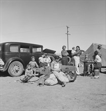 Families from the Dust Bowl in Texas in an overnight roadside camp near Calipatria, California, 1937 Creator: Dorothea Lange.