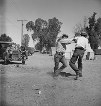 Recreation in a migratory agricultural workers' camp near Holtville, California, 1937. Creator: Dorothea Lange.