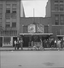 Idle men attend the morning movies, Oklahoma City, Oklahoma, 1937. Creator: Dorothea Lange.