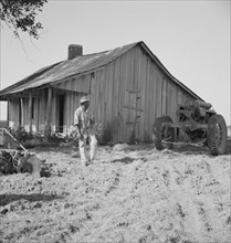 Colored tractor driver and empty cabin, Aldridge Plantation near Leland, Mississippi, 1937. Creator: Dorothea Lange.