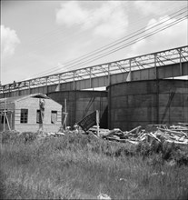 Large turpentine still and processing plant near Valdosta, Georgia, 1937. Creator: Dorothea Lange.