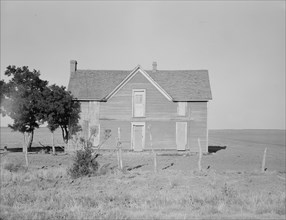 Vacant farmhouse in area of mechanization and drought near Olustee, Oklahoma, 1938. Creator: Dorothea Lange.