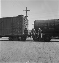 Colored itinerants on oil tank cars passing through Kingsbury, California, 1938. Creator: Dorothea Lange.