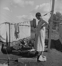 Women in auto camp for migrant citrus workers, Tulare County, California, 1938. Creator: Dorothea Lange.