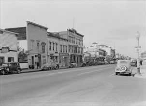 Up the main street of a valley town, Gilroy, California, 1938. Creator: Dorothea Lange.