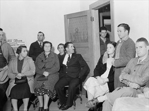 Night meeting in the FSA office, Tulare County, California, 1938. Creator: Dorothea Lange.