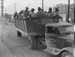 Cotton hoers from Memphis bound for the Wilson Plantation in Arkansas, forty-three miles away, 1937. Creator: Dorothea Lange.