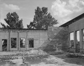 Some of the walls of the bank still stand at Fullerton, Louisiana, abandoned lumber town, 1937. Creator: Dorothea Lange.