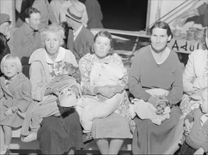 Mothers on the sidelines watch the Halloween party at Shafter migrant camp, California, 1938. Creator: Dorothea Lange.
