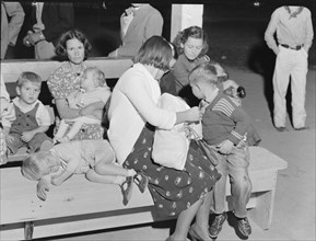 At the end of the Halloween party at Shafter migrant camp, California, 1938. Creator: Dorothea Lange.