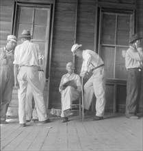 Farmers at tobacco auction, Douglas, Georgia, 1938. Creator: Dorothea Lange.