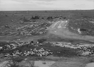 Debris left out on the flats where squatters' camp stood, Kern County, 1939. Creator: Dorothea Lange.