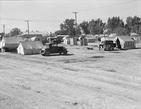Migratory labor housing during carrot harvest, near Holtville, Imperial Valley, California, 1939. Creator: Dorothea Lange.