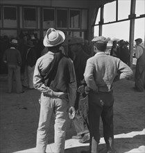 Outside the FSA grant office during the pea harvest, Calipatria, California, 1939. Creator: Dorothea Lange.