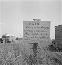 Sign on camp site opposite potato packing sheds, Tulelake, Siskiyou County, California, 1939. Creator: Dorothea Lange.