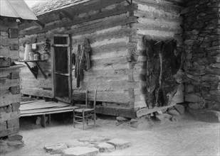 Construction detail of double log cabin of Negro share tenants, Person County, North Carolina, 1939. Creator: Dorothea Lange.