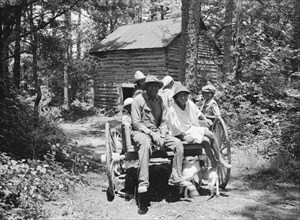 Possibly: Colored sharecropper and his children about to leave..., Shoofly, North Carolina, 1939. Creator: Dorothea Lange.