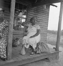 Possibly: Mother of sharecropper family and friend...the rain, Person County, North Carolina, 1939. Creator: Dorothea Lange.