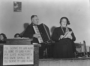 Adjutant and his wife sing, Salvation Army, San Francisco, California, 1939. Creator: Dorothea Lange.
