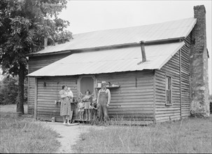 Tobacco sharecropper and his family at the back..., Person County, North Carolina, 1939. Creator: Dorothea Lange.