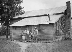 Tobacco sharecropper and his family at the back..., Person County, North Carolina, 1939. Creator: Dorothea Lange.