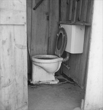 Toilet for ten cabins, men, women...in auto camp..., Greenfield, Salinas Valley, CA, 1939. Creator: Dorothea Lange.