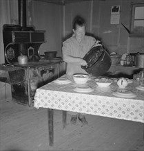 Mrs. Wardlow getting dinner after church in her basement..., Dead Ox Flat, Oregon, 1939. Creator: Dorothea Lange.