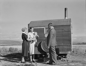 The doctor reassures the mother...the sick baby, Merrill, Klamath County, Oregon, 1939. Creator: Dorothea Lange.