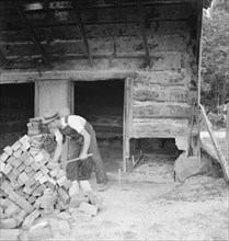 Putting in new flues in tobacco barn, Orange County, North Carolina, 1939. Creator: Dorothea Lange.