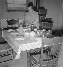Mrs. Wardlow bakes her own bread in her dugout house, Dead Ox Flat, Oregon, 1939. Creator: Dorothea Lange.