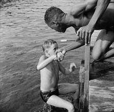 A scene at the swimming dock, Camp Nathan Hale, Southfields, New York, 1943 Creator: Gordon Parks.