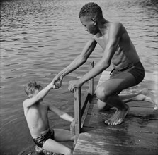 A scene at the swimming dock, Camp Nathan Hale, Southfields, New York, 1943 Creator: Gordon Parks.