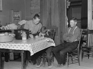 The Wardlow family in their dugout basement home on Sunday, Dead Ox Flat, Oregon, 1939. Creator: Dorothea Lange.