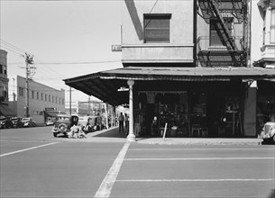 Secondhand store, street corner of San Joaquin Valley town on U.S. 99, Fresno, CA, 1939. Creator: Dorothea Lange.