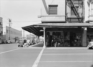 Secondhand store, street corner of San Joaquin Valley town on U.S. 99, Fresno, CA, 1939. Creator: Dorothea Lange.