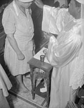 Reverend Clara Smith anointing a member of the St. Martin's Spiritual... Washington, D.C., 1942. Creator: Gordon Parks.