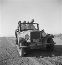 Eight related persons...in search of employment as pea pickers, on US80, Imperial Valley, CA, 1939. Creator: Dorothea Lange.