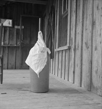 Pottery butter churn on porch of Negro tenant..., Randolph County, North Carolina, 1939. Creator: Dorothea Lange.