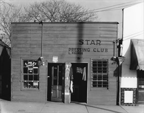 Negro shop, Shop fronts, laundry and barber shop, Vicksburg, Mississippi, 1936. Creator: Walker Evans.