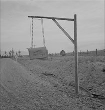 Swinging mail boxes in country where snow is deep in winter, Boundary County, Idaho, 1939. Creator: Dorothea Lange.
