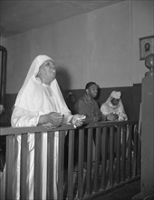 A disciple of the St. Martin's Spiritual Church praying before the altar..., Washington, D.C., 1942. Creator: Gordon Parks.
