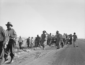 Migratory agricultural workers - cotton hoers, near Los Banos, California, 1939. Creator: Dorothea Lange.