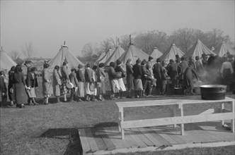 Possibly: Refugees lined up at meal time in the camp for white flood...Forest City, Arkansas, 1937. Creator: Walker Evans.