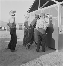 Applicants at registration tent on opening day...FSA camp, Merrill, Klamath County, Oregon, 1939. Creator: Dorothea Lange.