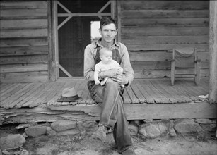Mr. Whitfield, tobacco sharecropper with baby..., North Carolina, Person County, 1939. Creator: Dorothea Lange.
