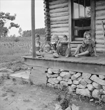 Millworker's children eating watermelon on porch..., Person County, North Carolina, 1939. Creator: Dorothea Lange.