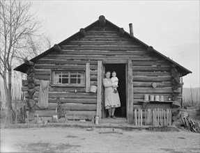 Log house now occupied and enlarged by the Halley family, Bonner County, Idaho, 1939. Creator: Dorothea Lange.