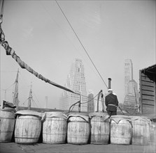 Barrels of fish on the docks at Fulton fish market ready to be shipped to..., New York, 1943. Creator: Gordon Parks.