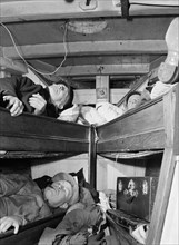 Gloucester fishermen resting in their bunks after unloading their catch at the..., New York, 1943. Creator: Gordon Parks.