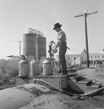 Drinking water for the whole town..., Tulelake, Siskiyou County, California, 1939. Creator: Dorothea Lange.